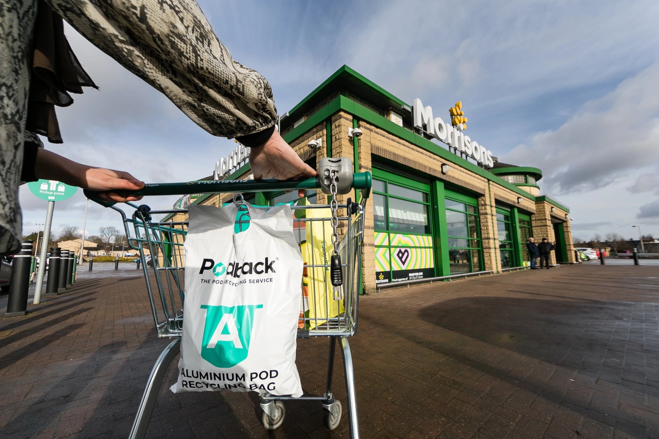 A Podback aluminium pod recycling bag hanging on a trolley outside a Morrisons supermarket