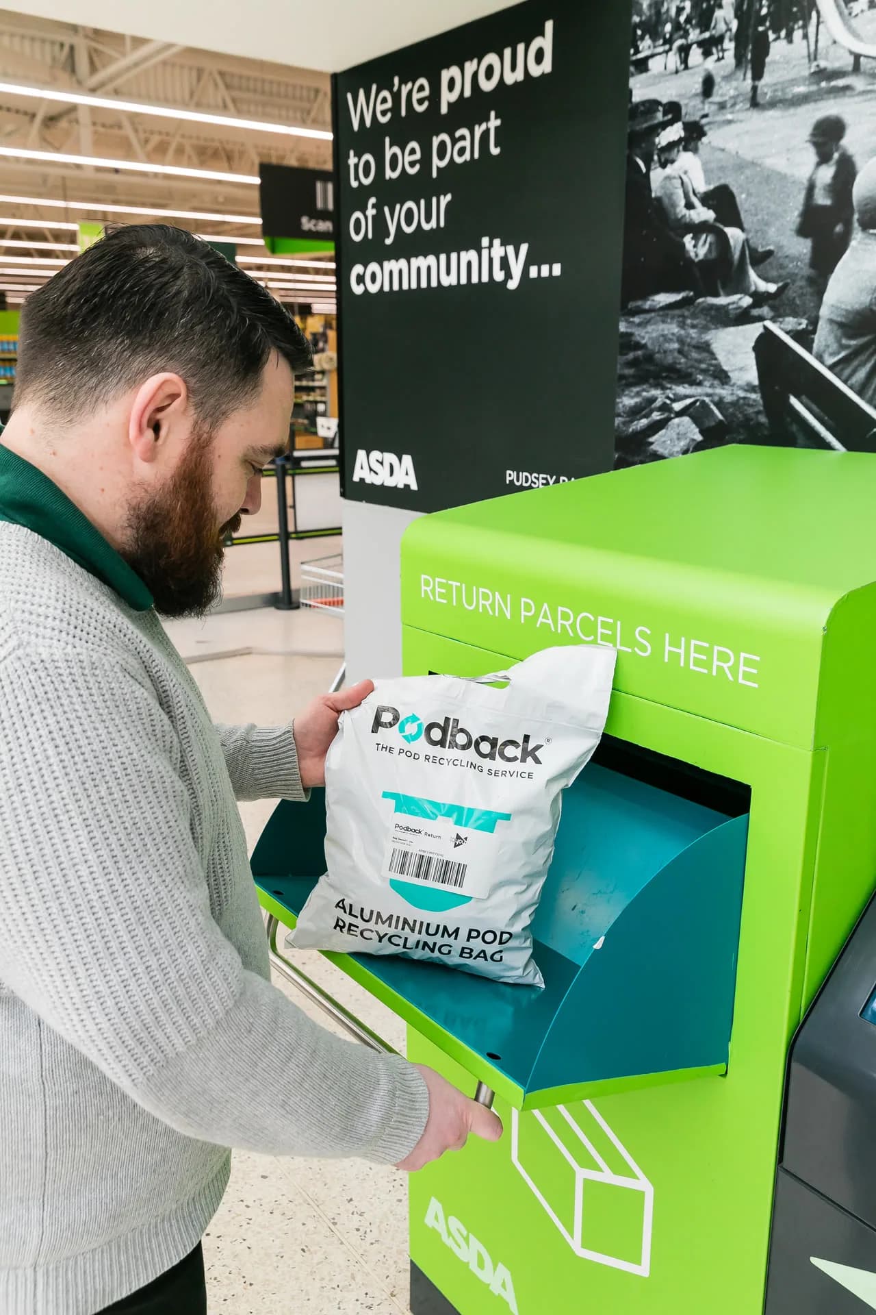 A customer posting a Podback aluminium pod recycling bag into an Asda returns unit